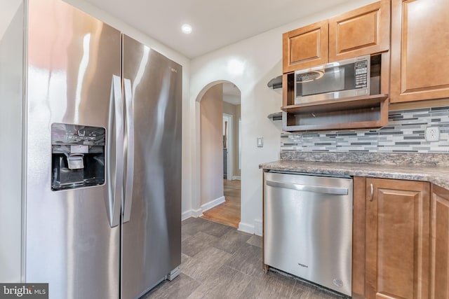 kitchen with appliances with stainless steel finishes and decorative backsplash