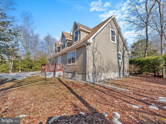 view of side of home with a wooden deck