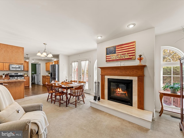 living room with french doors and light colored carpet