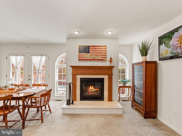 living area with light colored carpet and french doors