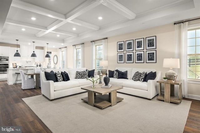 living room with hardwood / wood-style flooring, coffered ceiling, a wealth of natural light, and beam ceiling