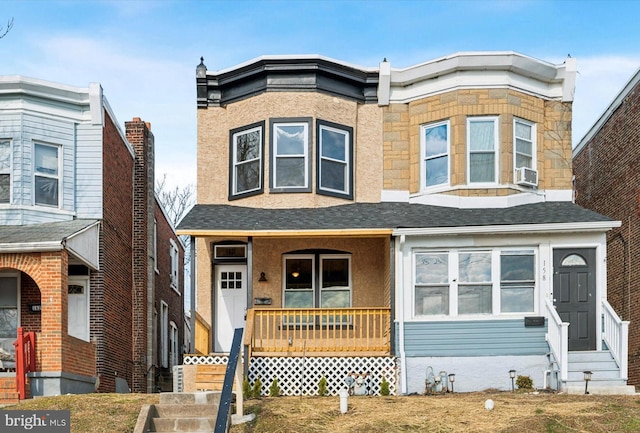 view of front facade with cooling unit and a porch