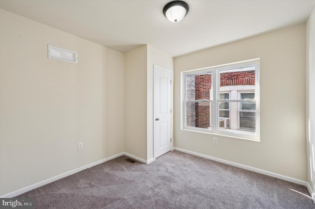 unfurnished room featuring light carpet