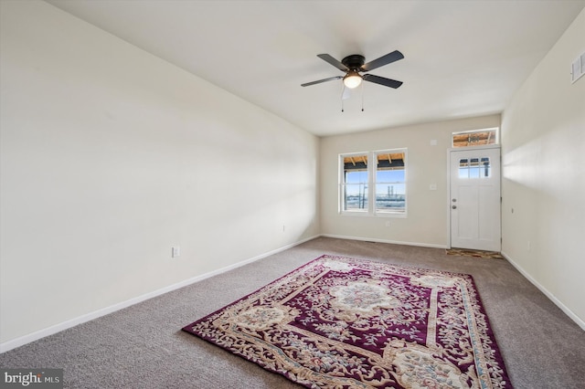 entryway with carpet floors and ceiling fan