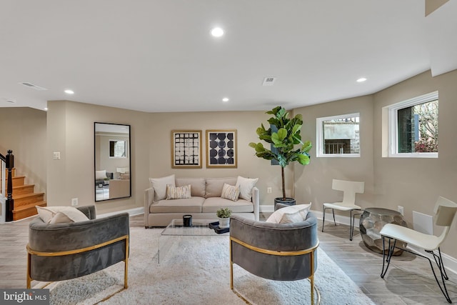 living room with baseboards, stairway, and recessed lighting