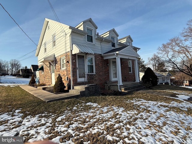 view of front of home featuring brick siding