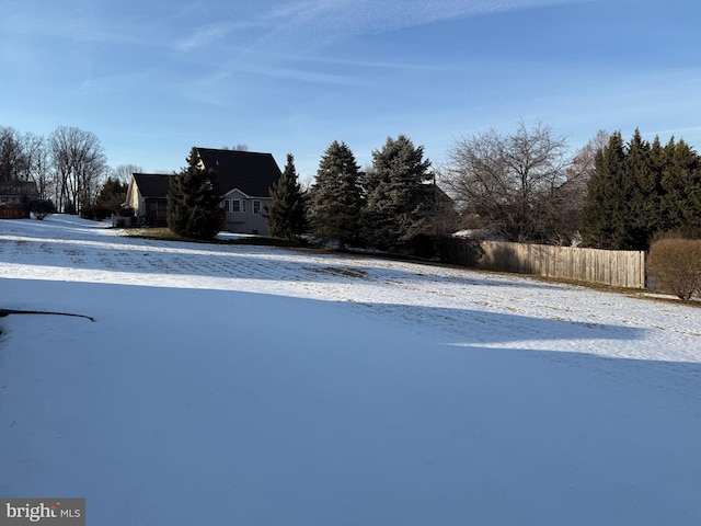 yard covered in snow with fence