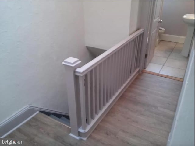 stairs featuring hardwood / wood-style flooring