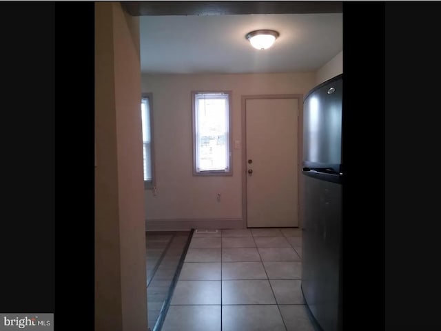 doorway featuring light tile patterned floors