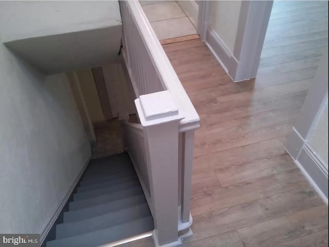 stairs featuring hardwood / wood-style floors