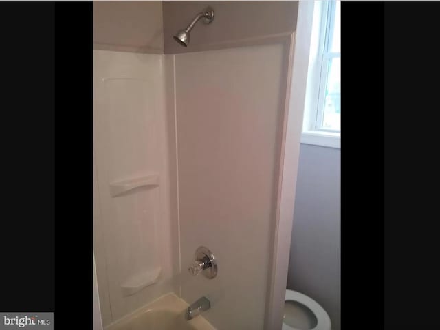 bathroom with shower / bathtub combination and toilet