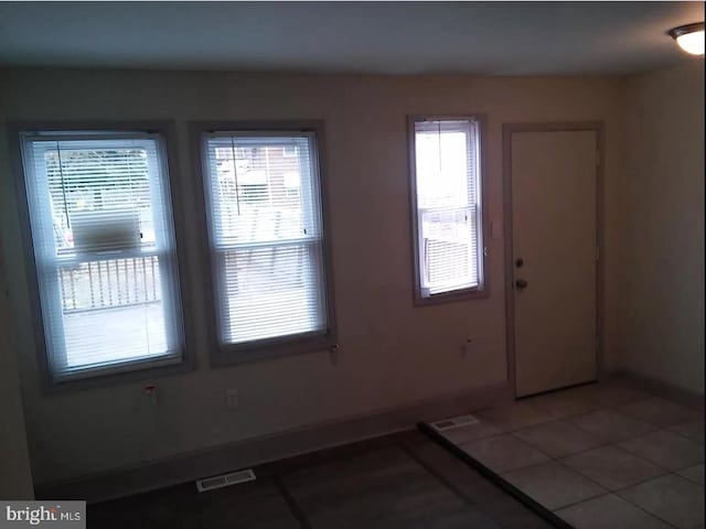 empty room with tile patterned flooring