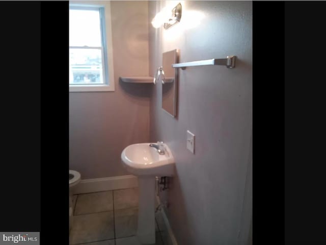 bathroom featuring tile patterned flooring and toilet