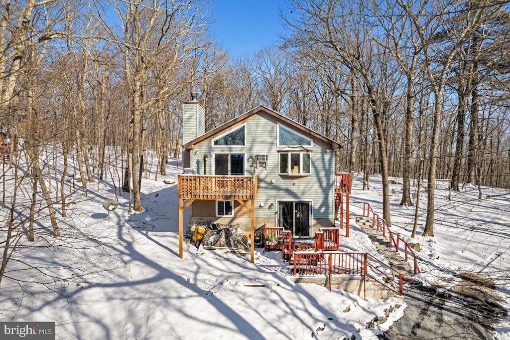 snow covered property featuring a deck