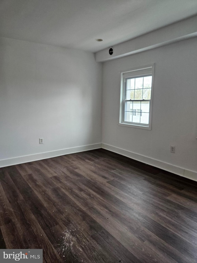 empty room with dark wood-type flooring