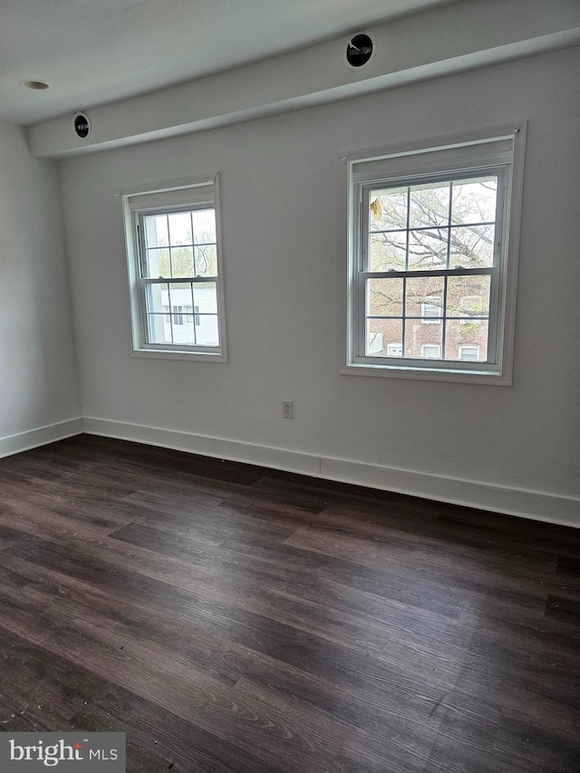 spare room with dark wood-type flooring