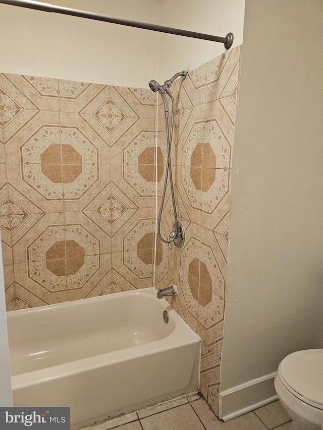 bathroom featuring tile patterned floors, toilet, and washtub / shower combination