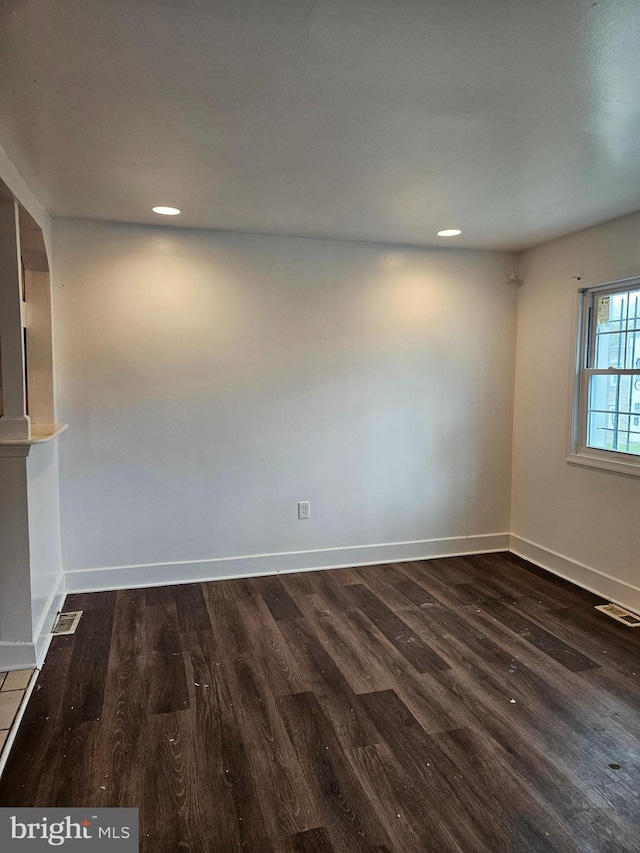 empty room featuring dark wood-type flooring