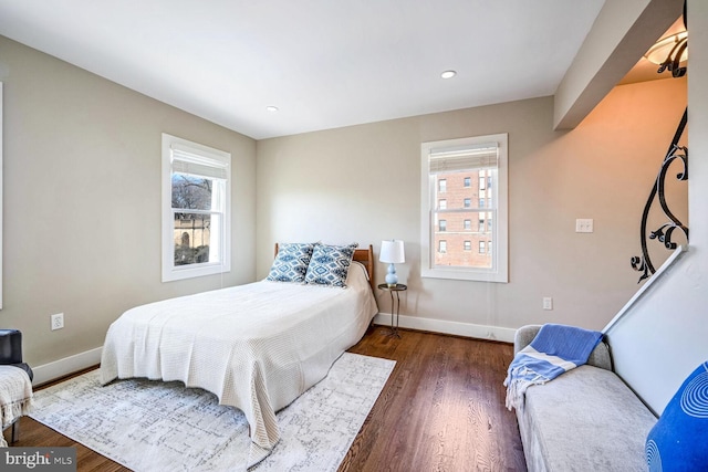 bedroom with dark wood-type flooring