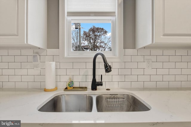 480 Natural Dam Rd, Gettysburg, PA 17325 - kitchen view of a sink, decorative backsplash, white cabinetry, and light stone counters
