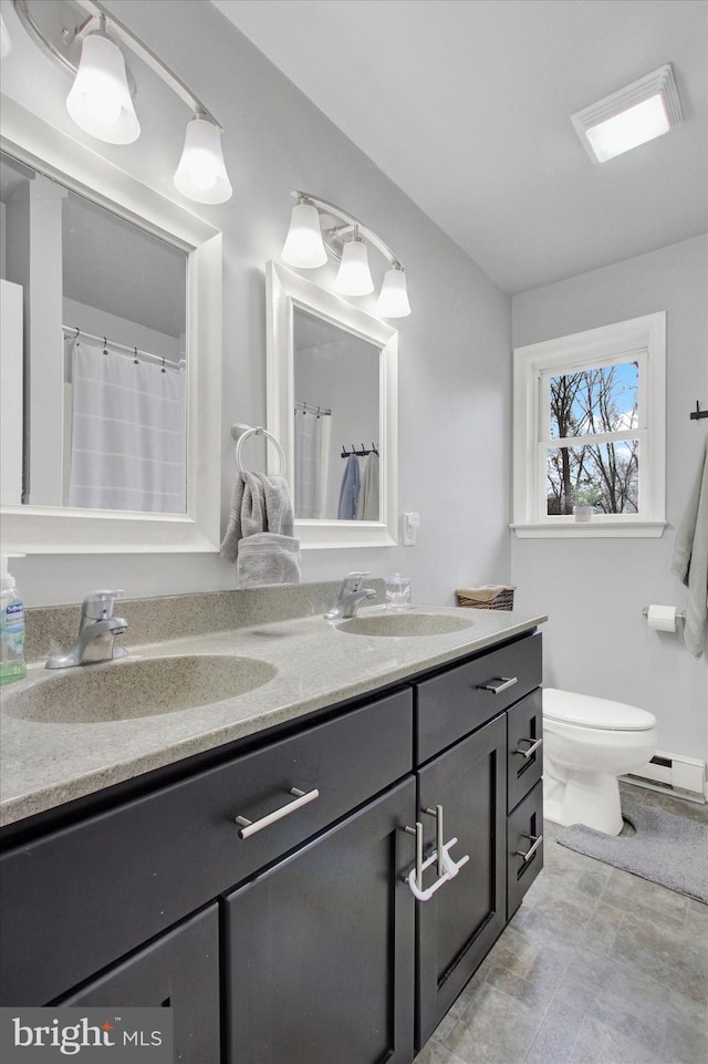 480 Natural Dam Rd, Gettysburg, PA 17325 - bathroom featuring double vanity, a baseboard heating unit, and toilet