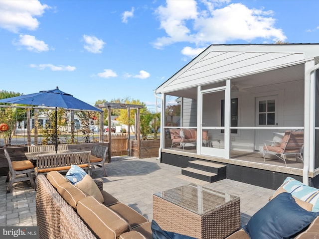 view of patio with an outdoor living space and a sunroom