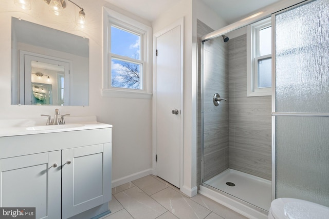 bathroom featuring vanity, toilet, tile patterned flooring, and a shower with door