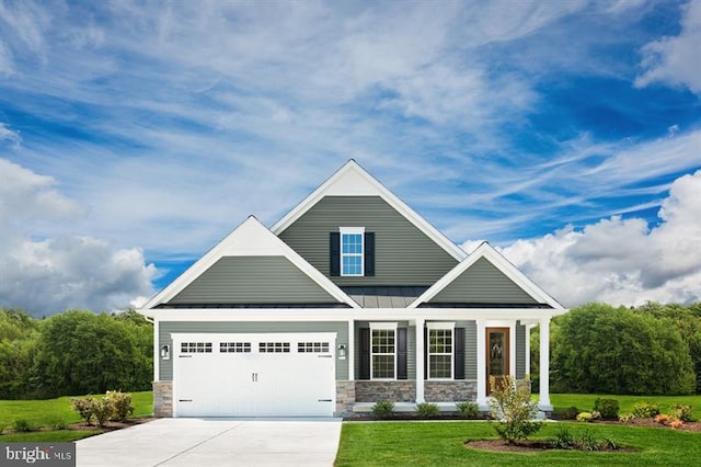 craftsman house with a garage and a front yard