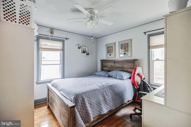 bedroom with light hardwood / wood-style flooring and ceiling fan