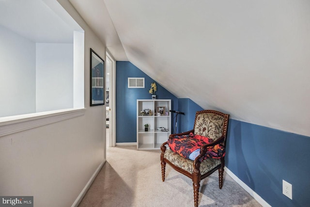 living area with vaulted ceiling and carpet