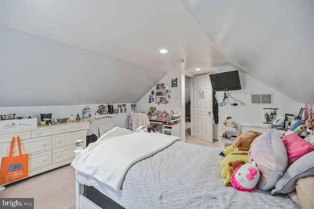 carpeted bedroom with lofted ceiling