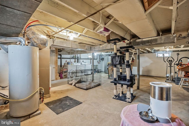 basement with gas water heater and independent washer and dryer