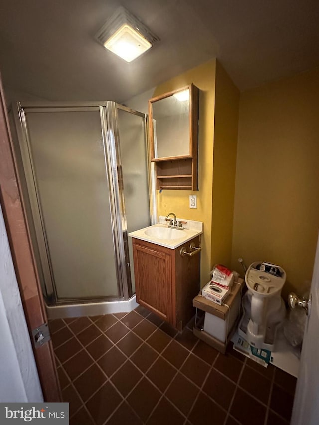 bathroom featuring vanity, tile patterned floors, and walk in shower