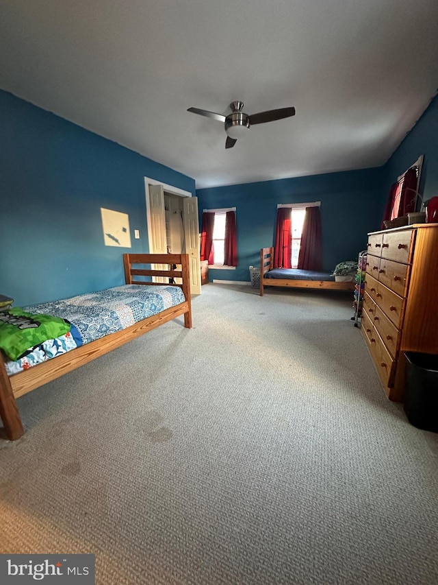 unfurnished bedroom featuring ceiling fan and carpet flooring