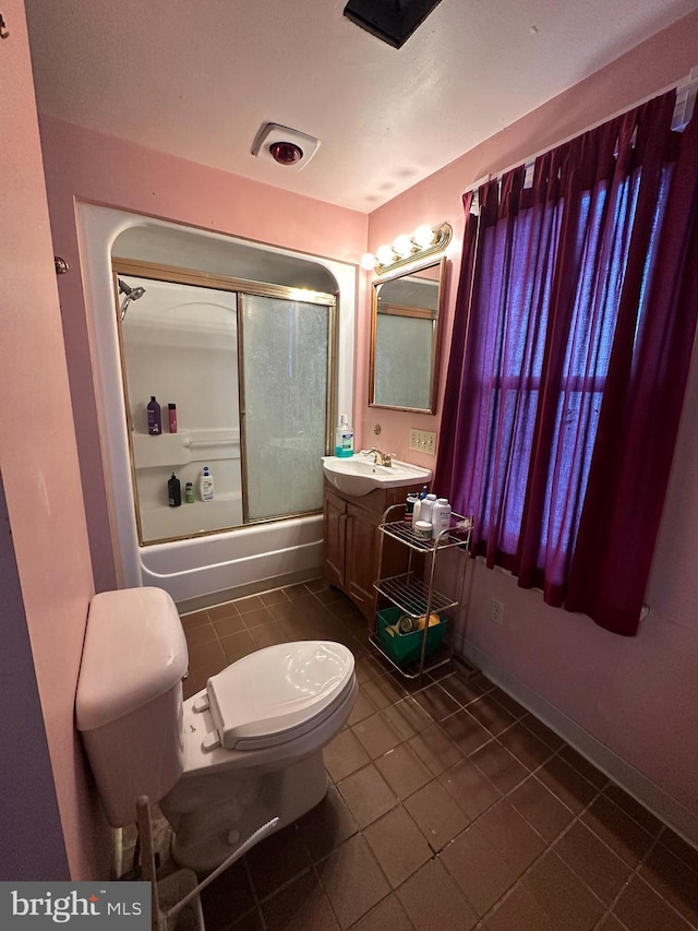 full bathroom featuring toilet, tile patterned floors, vanity, and shower / bath combination with glass door