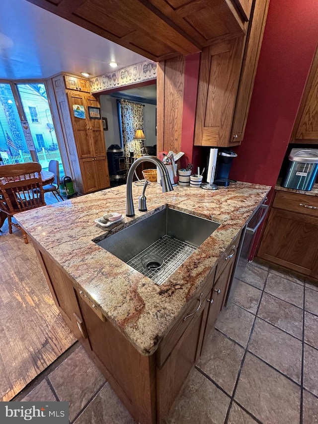 kitchen with light stone counters and sink