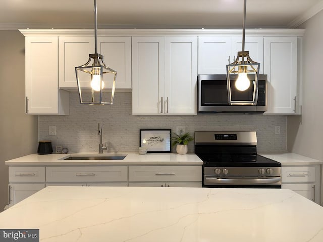 kitchen with white cabinetry, appliances with stainless steel finishes, sink, and hanging light fixtures