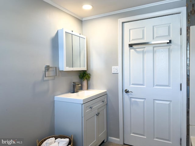 bathroom with ornamental molding and vanity