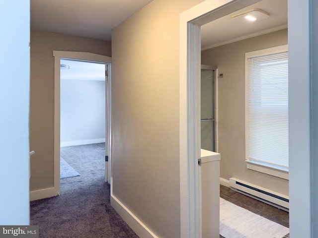 hallway with a baseboard radiator, ornamental molding, and carpet flooring