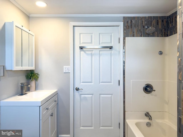 bathroom with crown molding, vanity, and shower / bathing tub combination