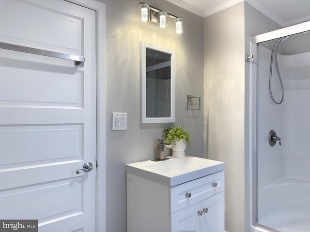 bathroom with ornamental molding, a shower with shower door, and vanity