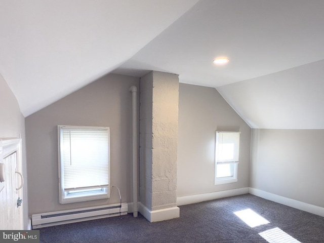 bonus room featuring lofted ceiling, a baseboard heating unit, and dark carpet