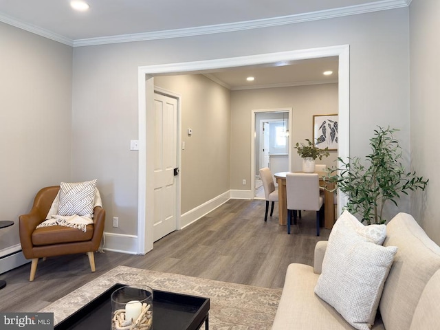 living room featuring hardwood / wood-style flooring and crown molding