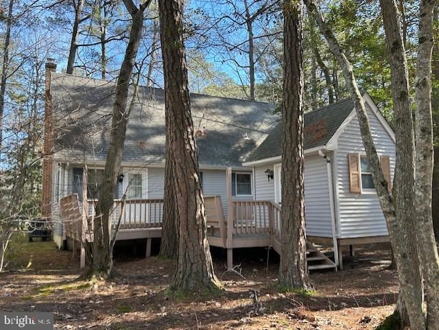 rear view of property with a wooden deck