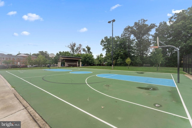 view of basketball court with a yard