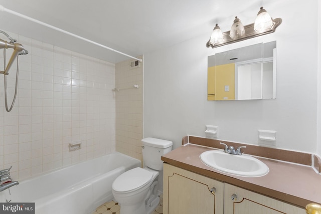 full bathroom with tiled shower / bath combo, vanity, and toilet