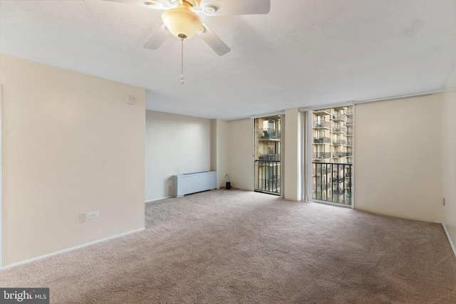 empty room with light carpet, ceiling fan, and a textured ceiling