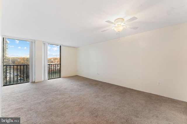 unfurnished room featuring carpet and ceiling fan