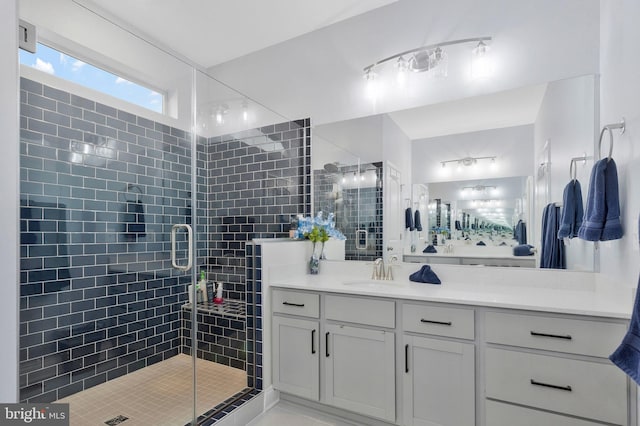 bathroom with vanity and a shower with door