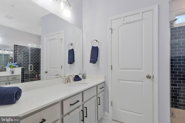 bathroom with vanity and a shower with door